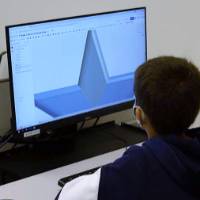 A student works on a CAD drawing